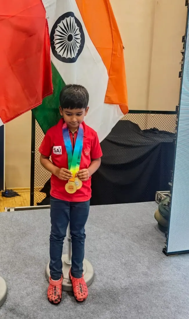 Riyaan Sidharth with the India flag and his medal at the ASEAN+ Championships