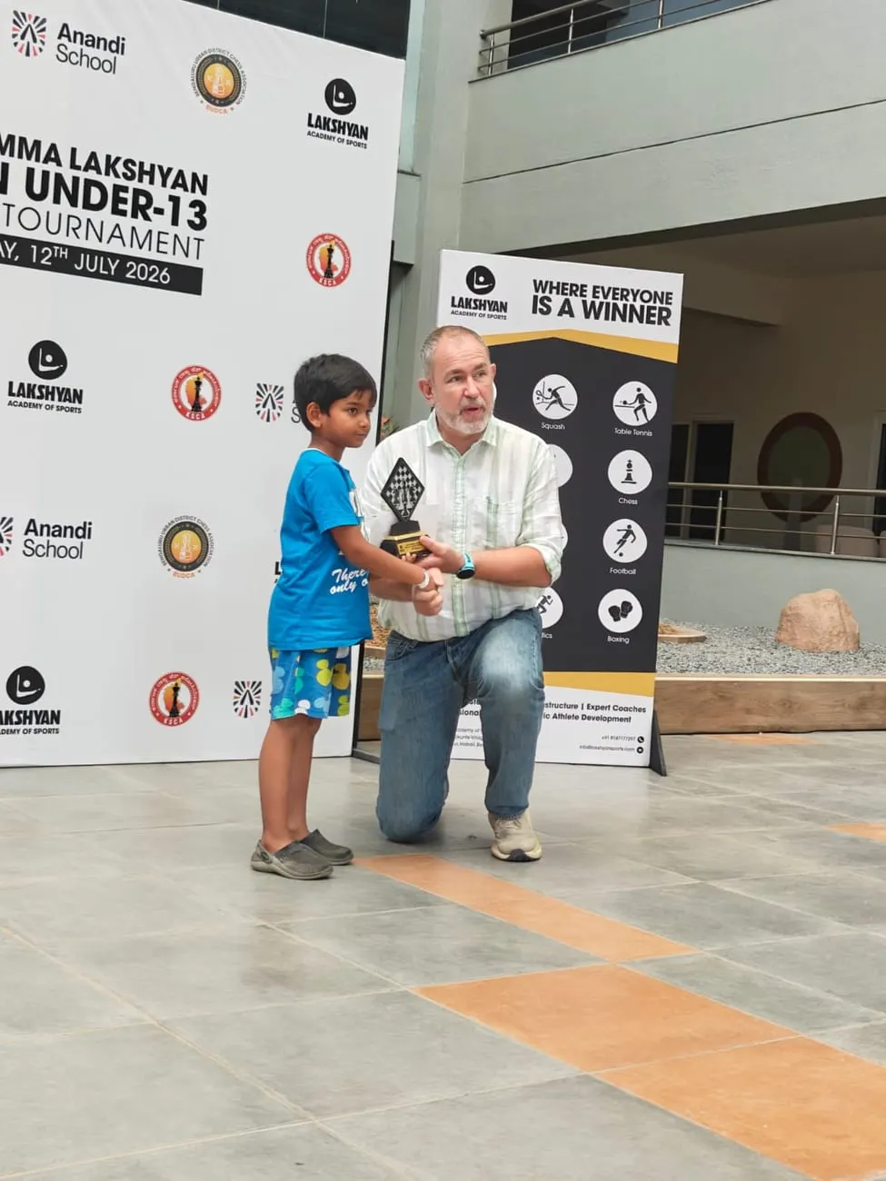Riyaan Sidharth receiving his runner-up trophy at the 4th Namma Lakshyan Open Under-13 tournament
