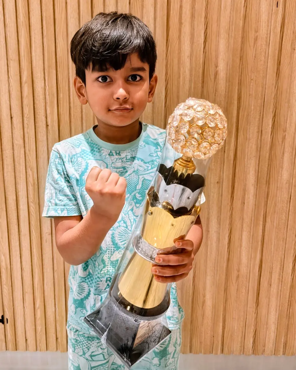 Riyaan Sidharth holding his Karnataka State Under-7 chess champion's trophy